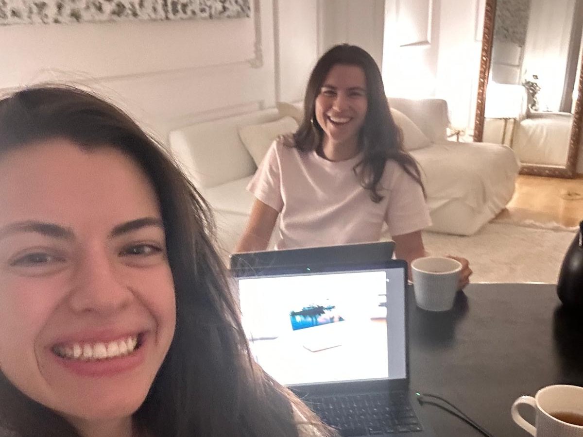 A warm building session with a friend, laptops, coffee, and a shared screen.